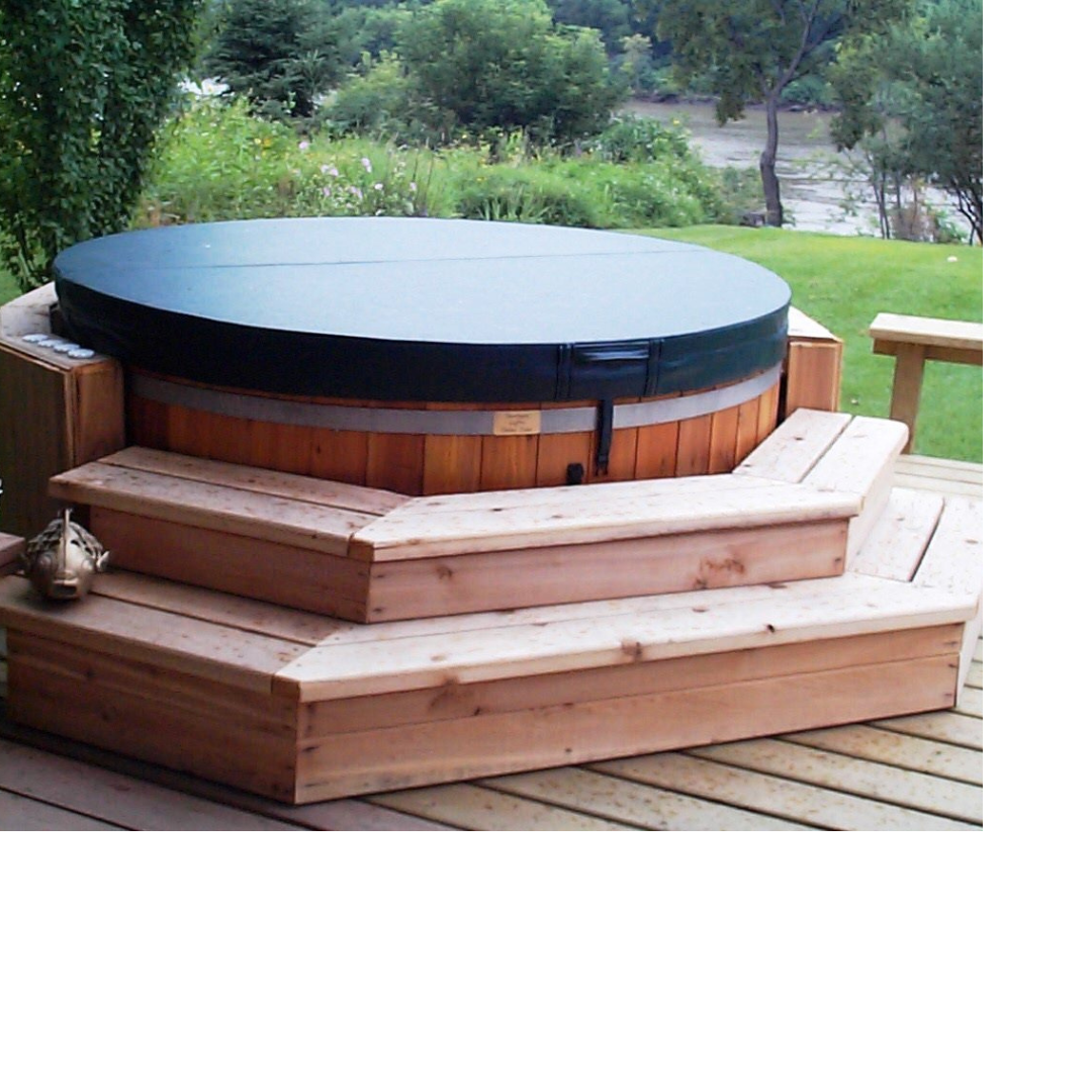 This image depicts a brown hot tub on an outdoor deck with its cover on.