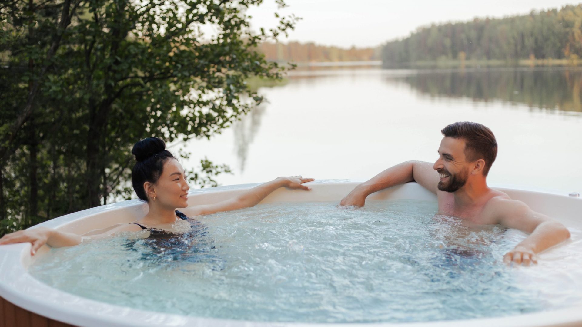 A man and woman relaxing in an outdoor hot tub