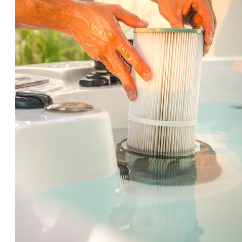 A man's hands replacing a hot tub's filter