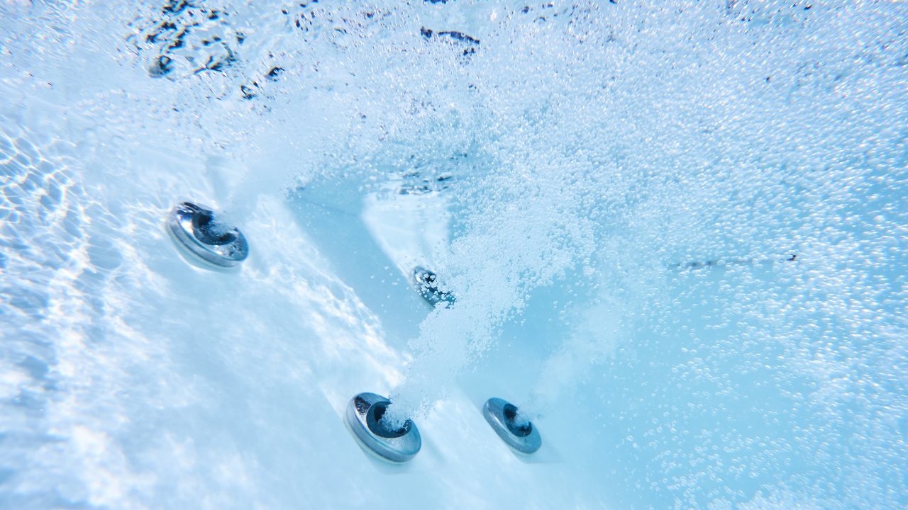 Underwater shot of water shooting out of the hot tub's jets