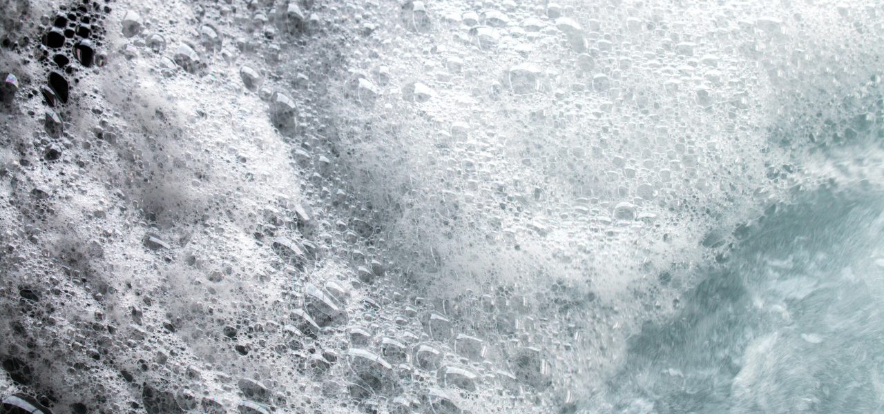 Close up image of very foamy hot tub water.